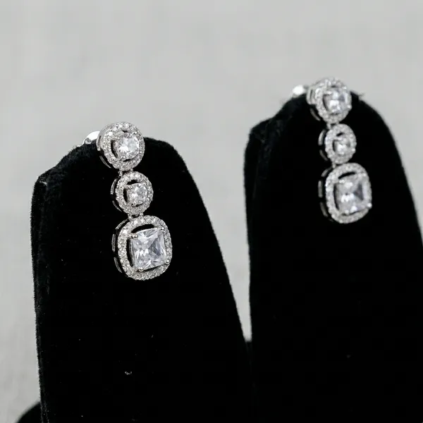 Three_Stone_Halo_Ring_With_White_Center_Stone