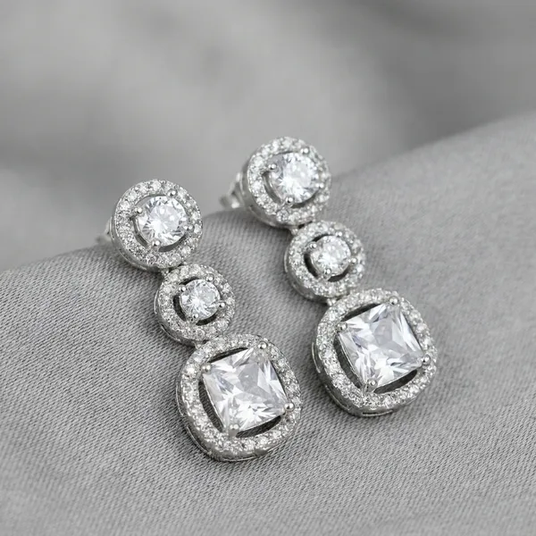 Three_Stone_Halo_Ring_With_White_Center_Stone