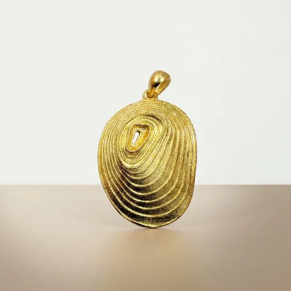 Gold-Toned_Oval_Pendant_With_Concentric_Spiral_Design
