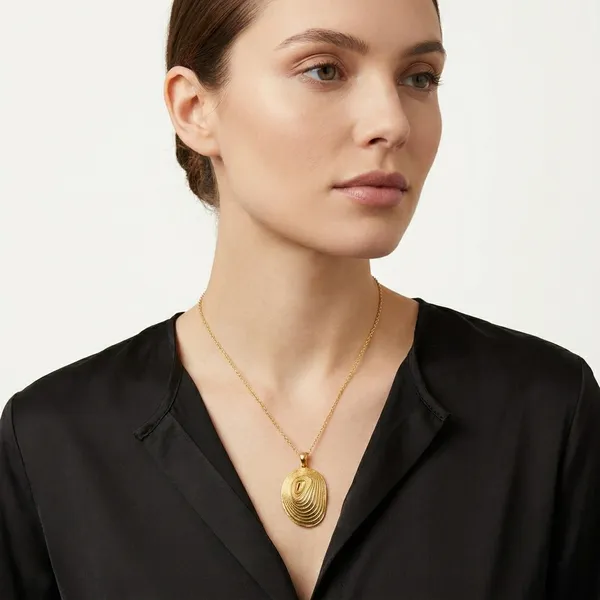 Gold-Toned_Oval_Pendant_With_Concentric_Spiral_Design