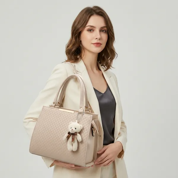 Elegant_Beige_Structured_Handbag_With_Detachable_Shoulder_Strap_And_Teddy_Bear_Charm