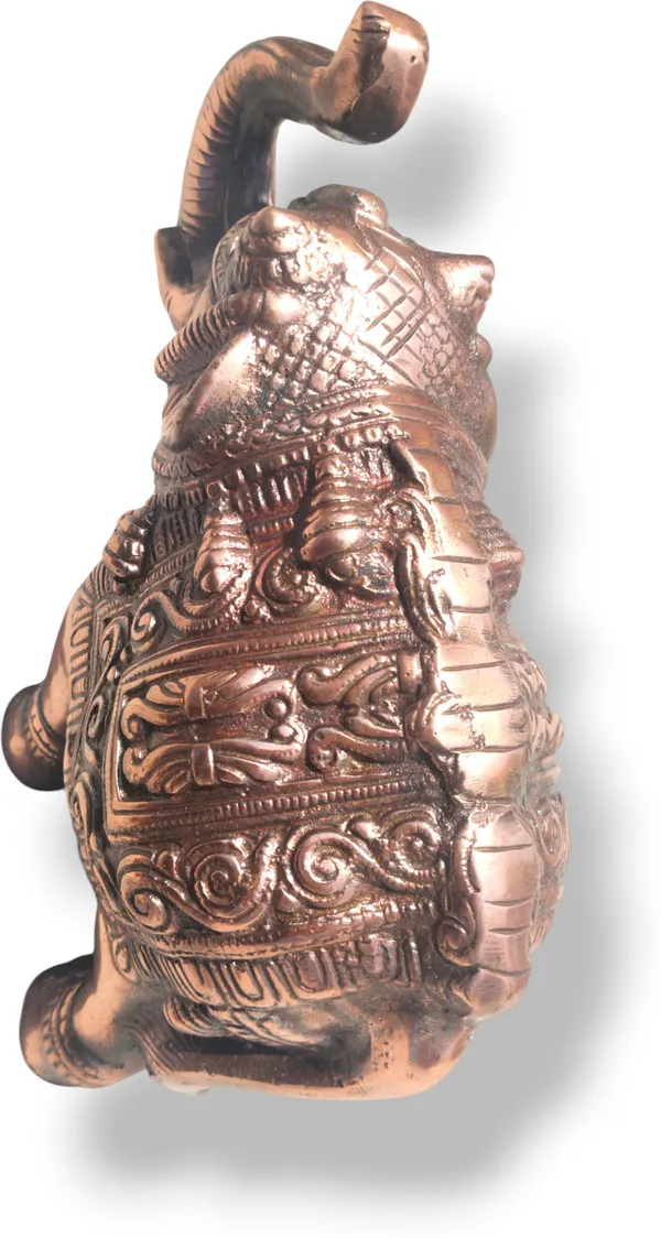 This_is_a_copper‑finished_decorative_statue_of_an_elephant_with_intricate_engraved_patterns_on_its_body,_head,_and_legs._The_craftsmanship_shows_detailed_filigree_work_and_an_antique,_regal_appearance,_making_it_a_stylish_décor_piece_for_display_or_gifting_-_9_INCH