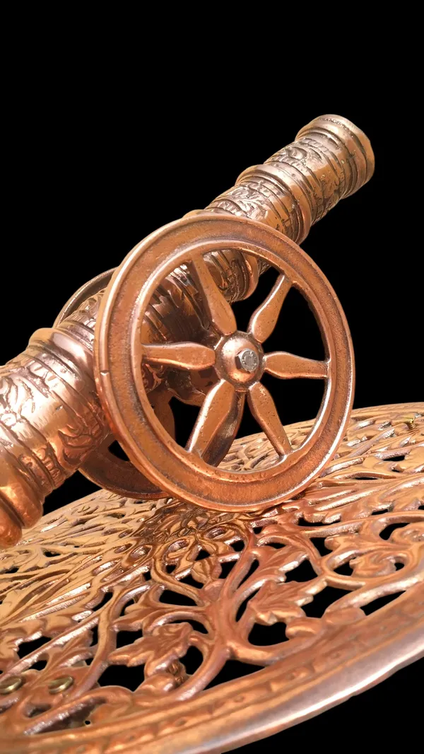 THE_EXQUISITE_ANTIQUE-STYLE_COPPER_FINISHED_METAL_SIDE_TABLE_PAIRED_WITH_A_DETAILED_CANNON_SCULPTURE.