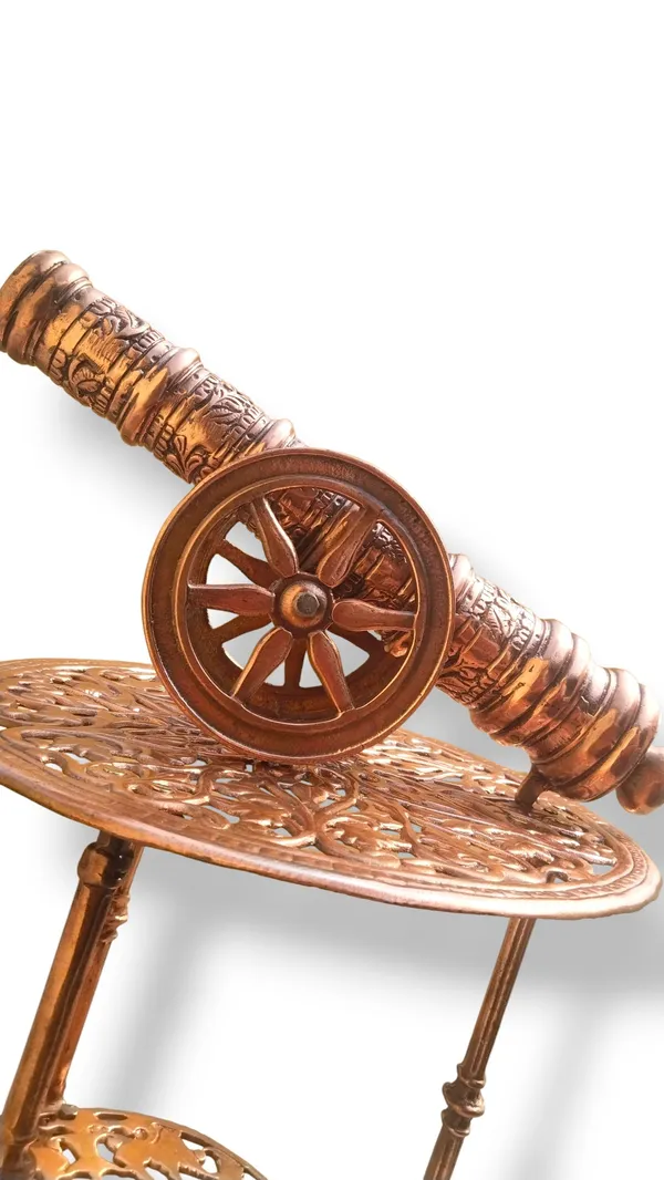 THE_EXQUISITE_ANTIQUE-STYLE_COPPER_FINISHED_METAL_SIDE_TABLE_PAIRED_WITH_A_DETAILED_CANNON_SCULPTURE.