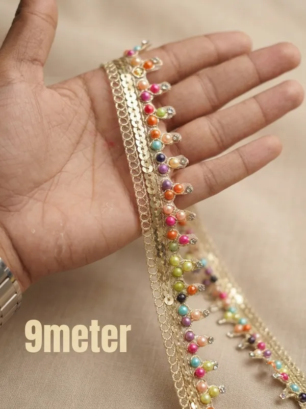 Bring_a_vibrant,_festive_burst_of_color_to_your_ethnic_wear_with_this_stunning_Multicolored_Bead_and_Sequin_Lace_Trim._Featuring_a_glistening_gold_woven_mesh_base_detailed_with_shimmering_sequins_and_hanging_loops_adorned_with_multi-colored_pearls_and_tiny_crystal_stones,_this_designer_border_adds_a_lively_and_artistic_touch_to_any_garment.