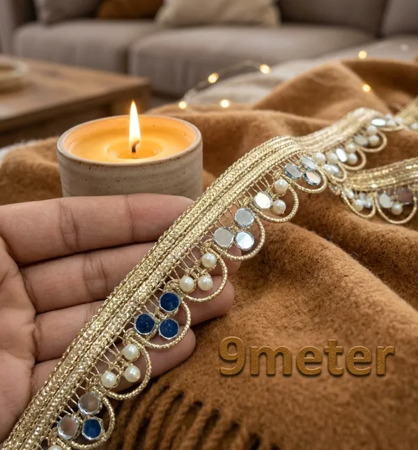 Bring_timeless_glamour_and_radiant_sparkle_to_your_ethnic_wardrobe_with_this_stunning_Gold_Mirror_and_Pearl_Lace_Trim._Expertly_designed_with_a_shimmering_metallic_gold_woven_base,_this_designer_border_features_an_intricate_loop_pattern_embellished_with_gleaming_reflective_mirrors_and_delicate_white_pearls.