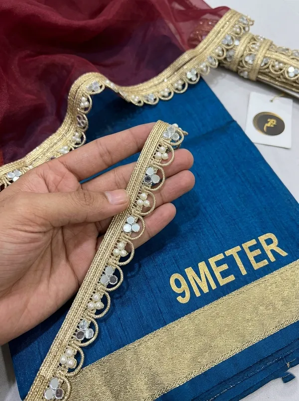 Bring_timeless_glamour_and_radiant_sparkle_to_your_ethnic_wardrobe_with_this_stunning_Gold_Mirror_and_Pearl_Lace_Trim._Expertly_designed_with_a_shimmering_metallic_gold_woven_base,_this_designer_border_features_an_intricate_loop_pattern_embellished_with_gleaming_reflective_mirrors_and_delicate_white_pearls.