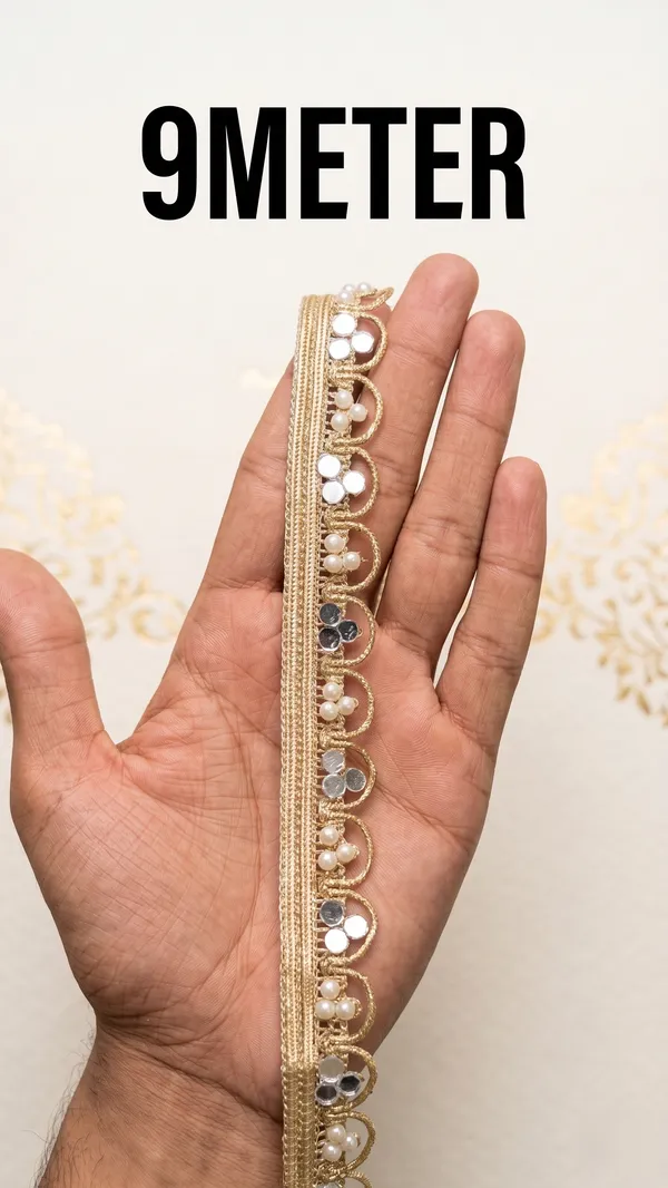 Dazzle_in_9_meters_of_pure_elegance_with_this_stunning_gold_lace_border,_intricately_woven_with_shimmering_mirror_work_and_delicate_pearls._Designed_to_transform_sarees,_lehengas,_and_kurtis,_this_luxurious_trim_adds_a_radiant,_festive_sparkle_to_your_ethnic_creations.