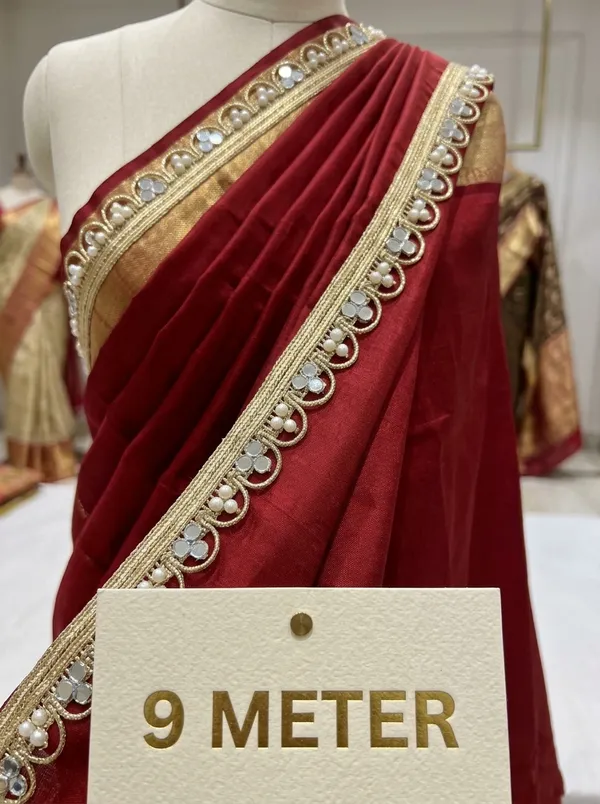 Dazzle_in_9_meters_of_pure_elegance_with_this_stunning_gold_lace_border,_intricately_woven_with_shimmering_mirror_work_and_delicate_pearls._Designed_to_transform_sarees,_lehengas,_and_kurtis,_this_luxurious_trim_adds_a_radiant,_festive_sparkle_to_your_ethnic_creations.