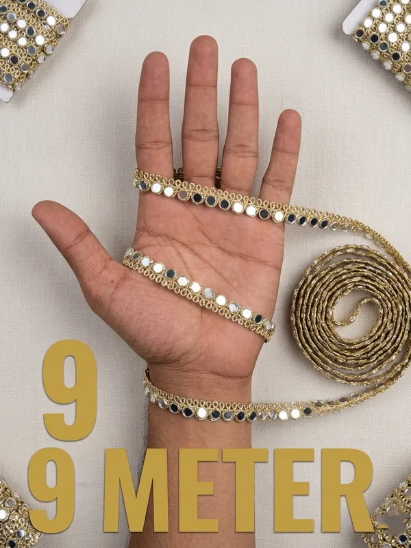 Dazzle_with_traditional_elegance_using_this_stunning_9-meter_gold_zari_lace,_intricately_embellished_with_shimmering_mirror-work_trim._Designed_to_catch_the_light_from_every_angle,_this_versatile_9-meter_border_adds_an_instant_touch_of_festive_glamour_and_royal_flair_to_your_sarees,_lehengas,_kurtis,_and_creative_craft_projects.