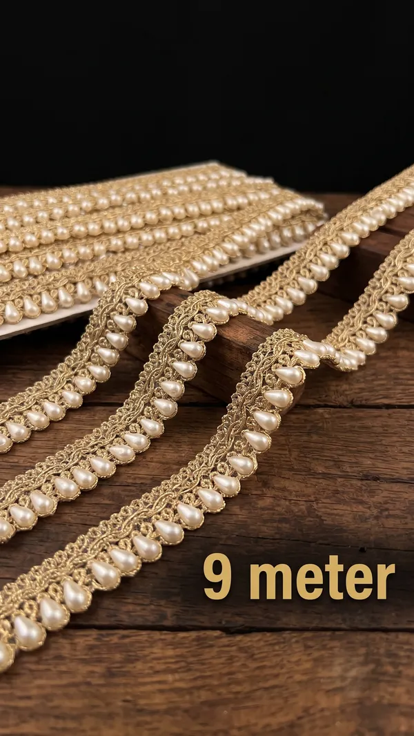 Elevate_your_ethnic_wear,_bridal_couture,_and_festive_outfits_with_this_breathtaking_Teardrop_Pearl_and_Gold_Lace_Trim._Expertly_designed_with_a_shimmering_metallic_gold_woven_base,_this_designer_border_features_a_continuous,_cascading_row_of_lustrous_teardrop-shaped_white_pearls_that_add_rich_texture_and_regal_sophistication_to_any_garment.