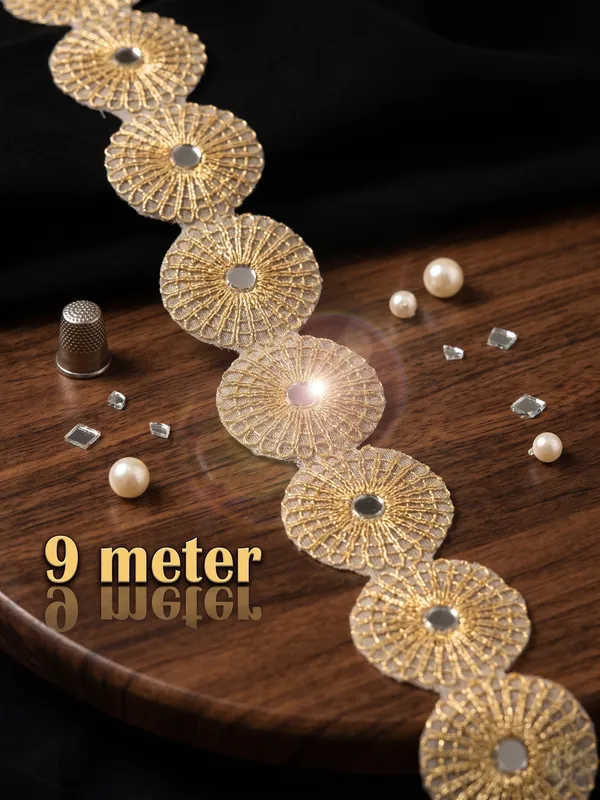 Enhance_your_ethnic_creations_with_this_striking_9-meter_gold_lace_border,_featuring_a_continuous_chain_of_ornate,_circular_floral_medallions_embedded_with_central_mirrors._Perfect_for_adding_traditional_charm_and_rich_texture_to_sarees,_lehengas,_and_festive_outfits,_this_unique_trim_brings_an_exquisite,_eye-catching_finish_to_your_designer_wardrobe.