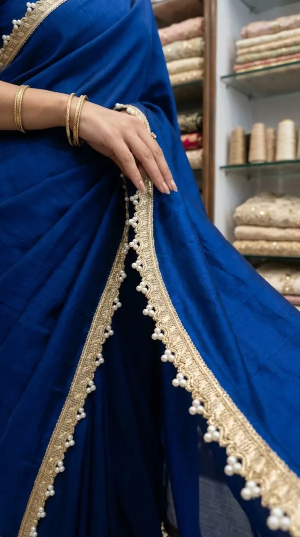 Enhance_your_ethnic_fashion_creations_and_designer_collections_with_this_magnificent_Gold_and_Pearl_Cluster_Lace_Trim._Expertly_crafted_with_a_shimmering_metallic_gold_woven_base_featuring_a_delicate_scalloped_edge,_this_designer_border_is_embellished_with_charming_clusters_of_round_white_pearls_for_an_opulent_finish.