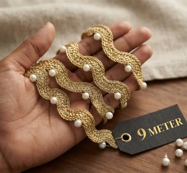 Enhance_your_ethnic_fashion_line_and_bridal_collections_with_this_magnificentWavy_Gold_and_Pearl_Lace_Trim._Featuring_a_unique,_fluid_wave_design_woven_from_gleaming_metallic_gold_yarn_and_accented_with_smooth,_evenly_spaced_pearls,_this_designer_border_adds_dynamic_texture_and_graceful_elegance_to_any_garment.