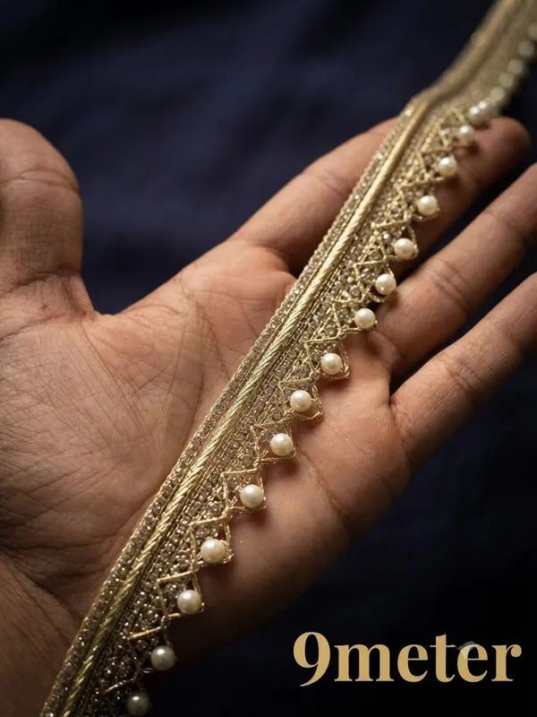 Enhance_your_ethnic_wear_and_designer_collections_with_this_exquisite_Metallic_Gold_and_Pearl_Beaded_Lace_Trim._Beautifully_crafted_with_a_structured,_shimmering_gold_woven_header_and_detailed_geometric_lattice_work,_this_designer_border_is_finished_with_a_charming_row_of_dangling_white_pearl_drops_for_an_opulent_touch.