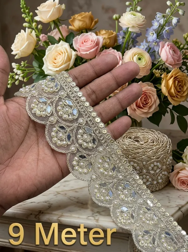 Infuse_your_ethnic_collections_with_royal_elegance_using_this_magnificent_Scalloped_Pearl_and_Mirror_Lace_Trim._Expertly_crafted_with_a_wide,_ornate_mesh_base_featuring_intricate_scalloped_arches_filled_with_floral-inspired_pearl_clusters_and_reflective_mirror_inserts,_this_designer_border_delivers_breathtaking_grandeur_to_high-end_apparel.