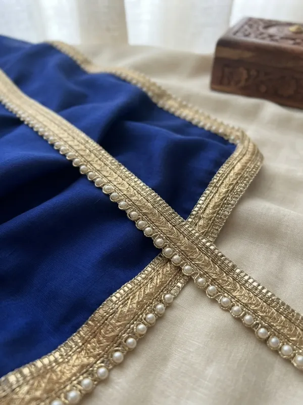 Upgrade_your_ethnic_and_couture_collections_with_this_sophisticated_Multi-Band_Gold_and_Pearl_Lace_Trim._Featuring_a_multi-layered_design_composed_of_a_shimmering_metallic_gold_braid,_a_textured_woven_center_band,_and_a_delicate_beaded_edge_lined_with_luminous_white_pearls,_this_designer_border_brings_refined_elegance_and_dimensional_richness_to_any_garment.