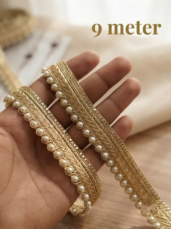 Upgrade_your_ethnic_and_couture_collections_with_this_sophisticated_Multi-Band_Gold_and_Pearl_Lace_Trim._Featuring_a_multi-layered_design_composed_of_a_shimmering_metallic_gold_braid,_a_textured_woven_center_band,_and_a_delicate_beaded_edge_lined_with_luminous_white_pearls,_this_designer_border_brings_refined_elegance_and_dimensional_richness_to_any_garment.