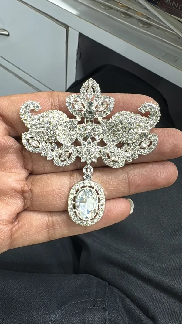 Ornate_Crystal_Brooch_with_Dangling_Oval_Pendant