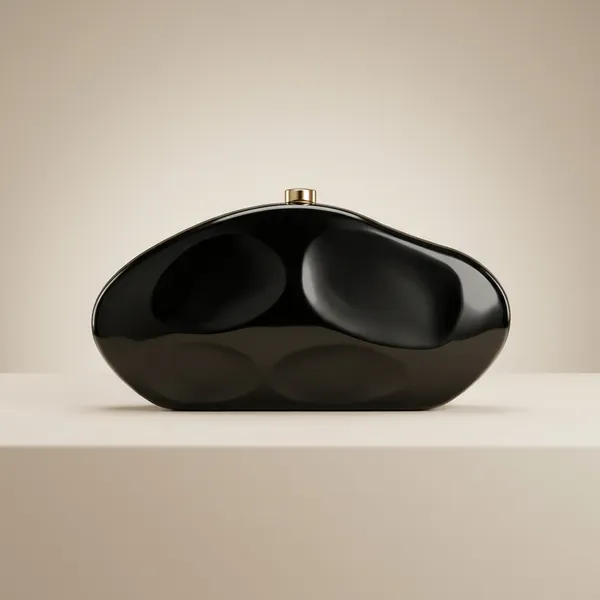 Elegant_Black_Clutch_With_Golden_Chain_And_Decorative_Brooch