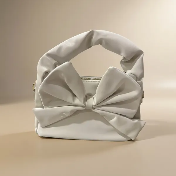 Elegant_Cream_Bow_Accent_Handbag_With_Twisted_Handle