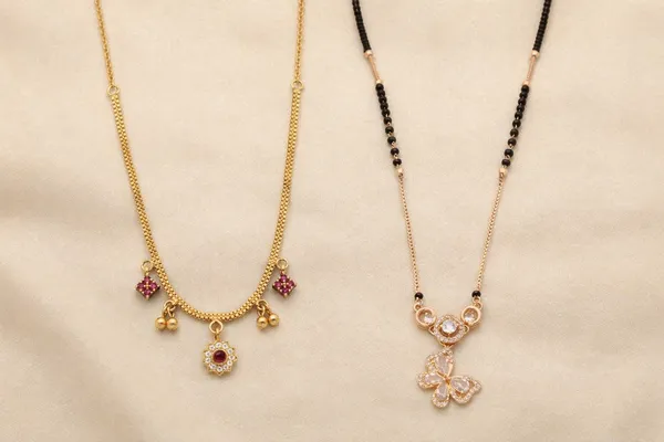 Gold-Toned_Floral_Charm_Necklace_With_Pink_Stones_And_Sparkling_Butterfly_Pendant_Necklace_With_Crystal_Accents_(Pack_Of_2)