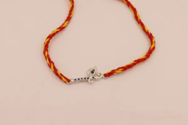 Divine_Flute_Rakhi_(Sterling_Silver_925)_in_Auspicious_Kalawa