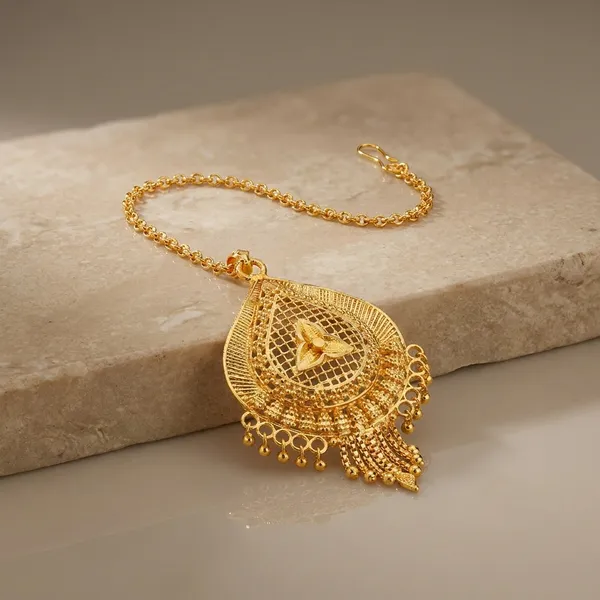 Traditional_Golden_Maang_Tikka_With_Intricate_Heart_Design
