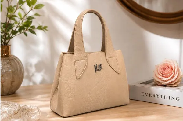 Elegant_Beige_Textured_Handbag_with_Metal_Logo
