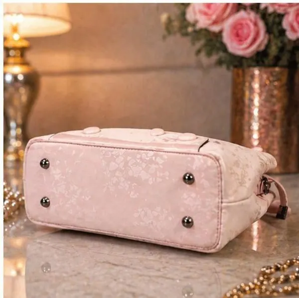 Elegant_Pink_Patent_Leather_Handbag_with_Embossed_Floral_Design
