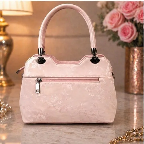 Elegant_Pink_Patent_Leather_Handbag_with_Embossed_Floral_Design