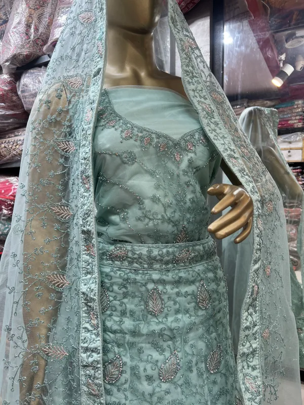 Mint_Green_Net_Lehenga_Choli_Set_With_Embellishments_And_Dupatta