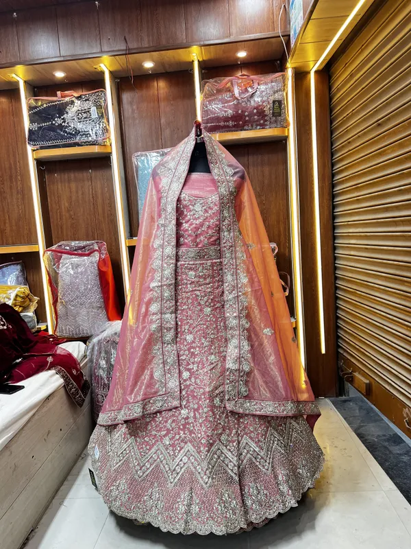 Pink_Net_Bridal_Lehenga_Choli_Set_With_Heavy_Embellished_Work_And_Dupatta