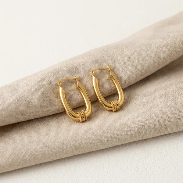 Gold_Toned_Twisted_Hoop_Earrings_With_Textured_Detail