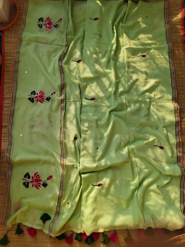Elegant_Green_Mulmul_Saree_With_Embroidered_Lotus_Floral_Motifs_And_Tassels