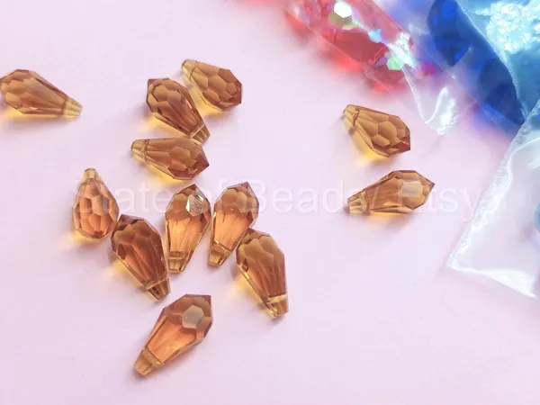 Genuine_Swarovski_Golden_Teardrop_Charm_Beads_|_5.5mm_|_4_Pcs