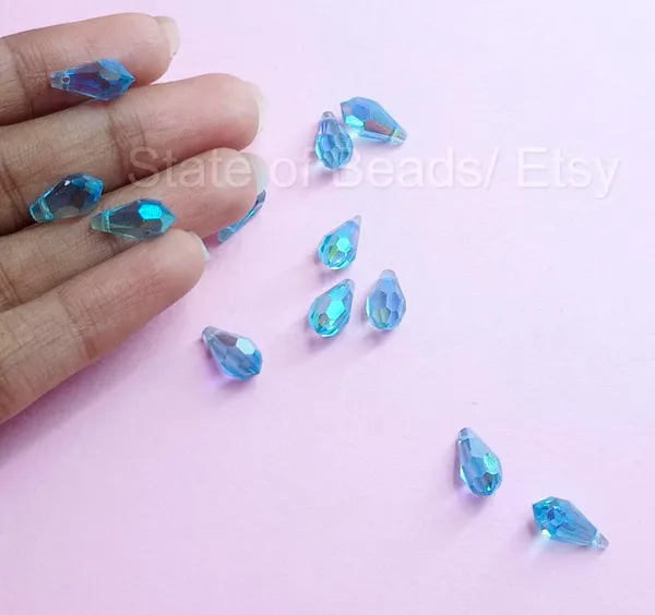 Genuine_Swarovski_Sky_Blue_Teardrop_Charm_Beads_|_5.5mm_|_4_Pcs