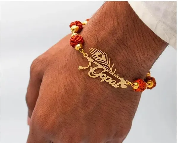 Personalized_Name_Rakhi_with_Flute_&_Peacock_Feather_Design_–_Custom_Gold-Finish_Religious_Rakhi_for_Brother