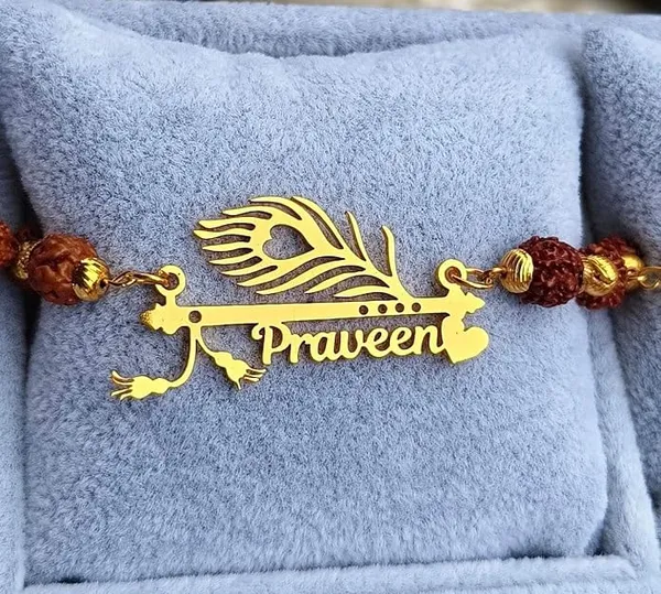 Personalized_Name_Rakhi_with_Flute_&_Peacock_Feather_Design_–_Custom_Gold-Finish_Religious_Rakhi_for_Brother