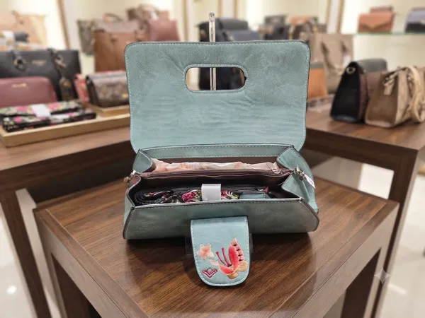 Premium_Ice_Blue_Faux_Leather_Handbag_with_Vibrant_Rose_Embroidery_and_Magnetic_Flap