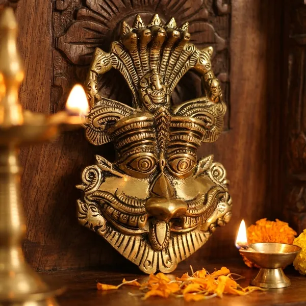 Metal_Gold_Nazar_Battu_With_Naag_Ganesha_For_Evil_Eye_Protection_And_Nazar_Suraksha_Bad_Eye_Suraksha_Kavach_Mask_For_Home_Office_Wall_Door_Hanging_Decor_Accessories_Feng_Shui_Vastu_Showpiece_Wall_Hanging_Is_A_Representation_Of_A_Kirtimukha_With_A_Seated_Ganesha_Figure_On_Top