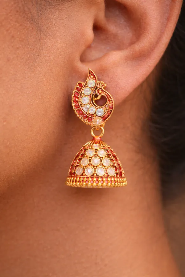 Elegant_Red_peacock-inspired_jhumka_earrings_adorned_with_sparkling_stones_and_intricate_gold_detailing