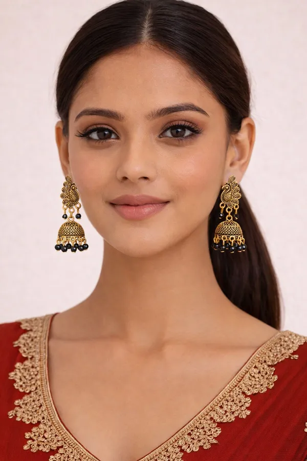 Elegant_peacock-inspired_Black_and_gold_jhumka_earrings_adorned_with_intricate_detailing_and_black_bead_accents
