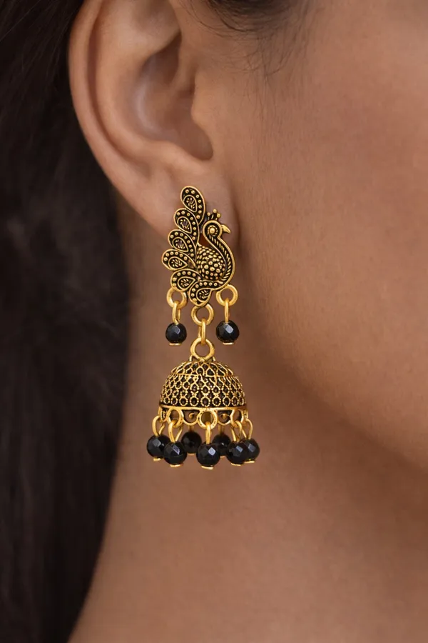 Elegant_peacock-inspired_Black_and_gold_jhumka_earrings_adorned_with_intricate_detailing_and_black_bead_accents