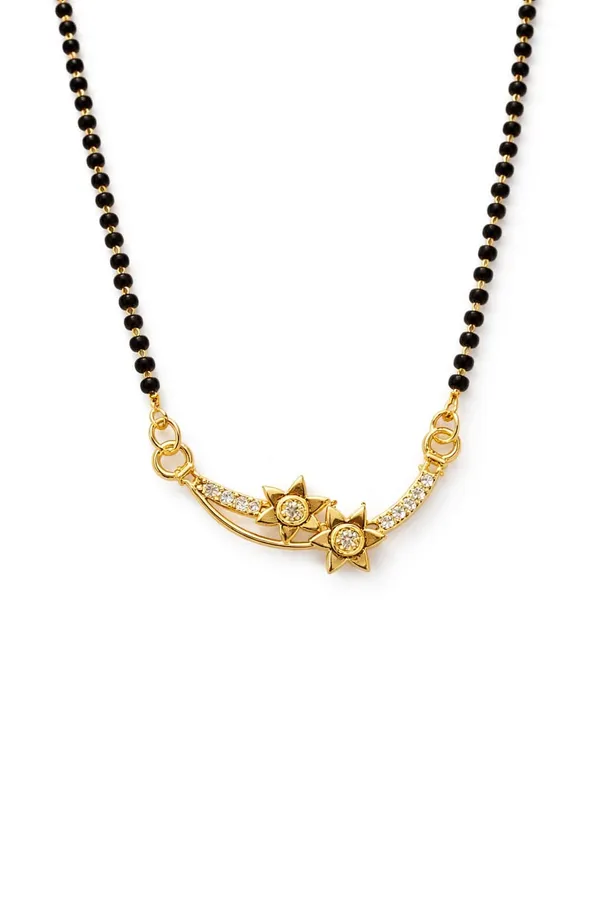 Traditional_gold-tone_mangalsutra_featuring_a_detailed_floral_pendant_with_twin_black_bead_chains