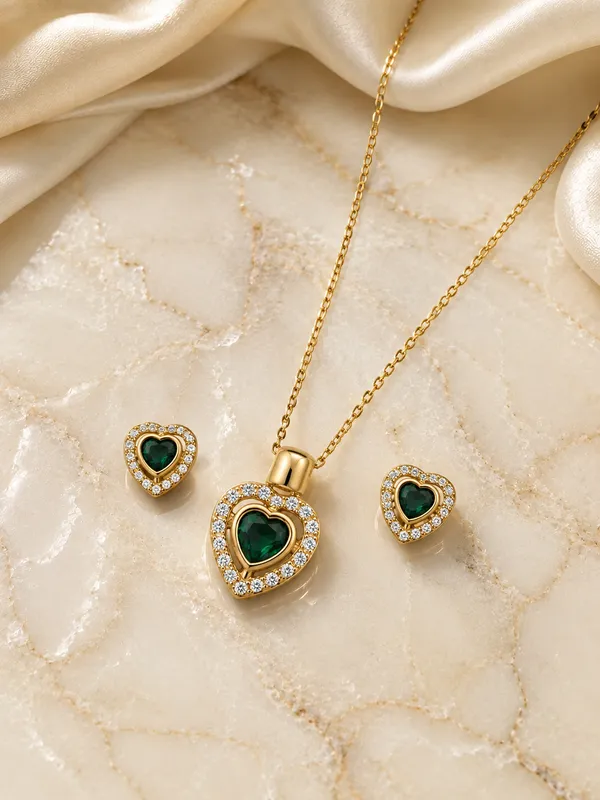 Elegant_heart-shaped_emerald-green_stones_with_sparkling_crystal_accents_and_a_polished_gold-tone_finish