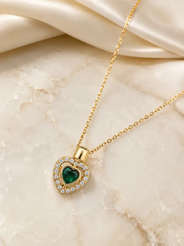 Elegant_heart-shaped_emerald-green_stones_with_sparkling_crystal_accents_and_a_polished_gold-tone_finish