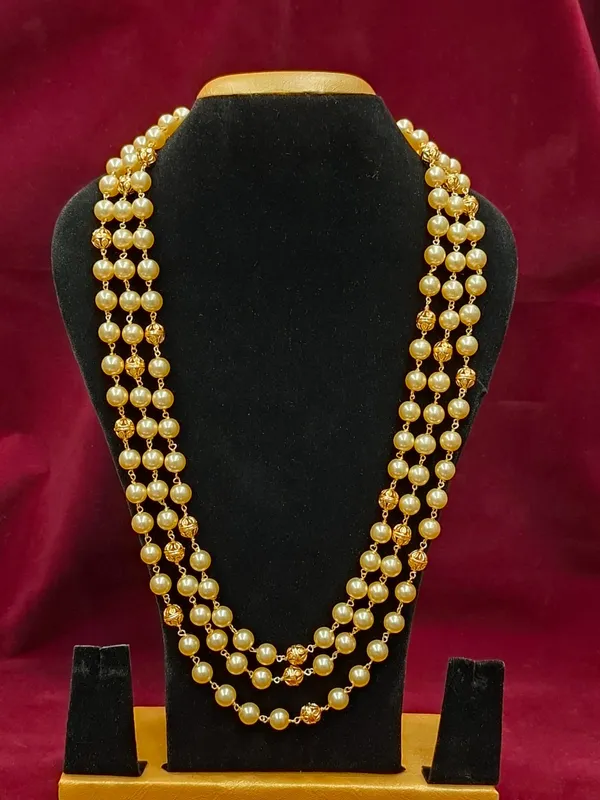 Three-Strand_Cream_Pearl_Necklace_with_Textured_Gold_Spacer_Beads