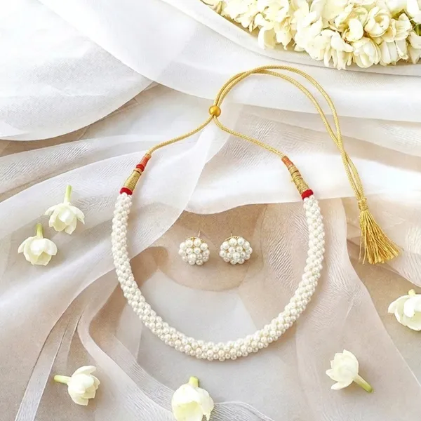 Elegant_White_Embroidered_Sheer_Saree_with_Pearl_Jewelry_Set