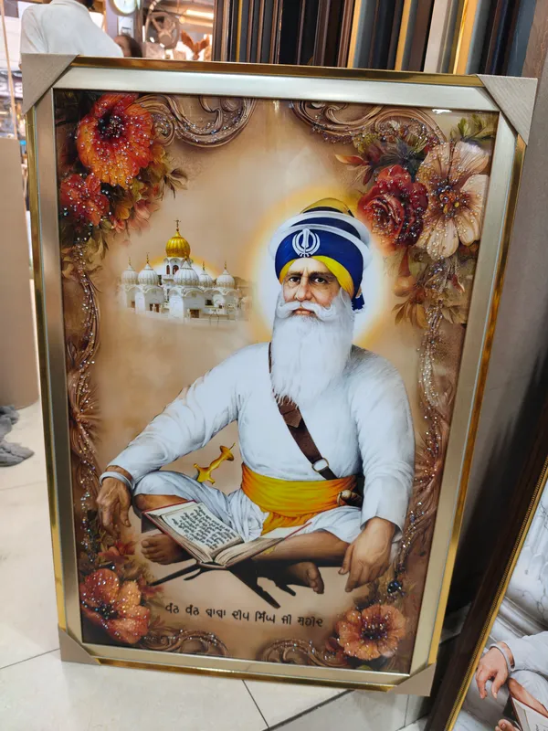 Decorative_Sai_Baba_Religious_Portrait_With_Ornate_Floral_Frame